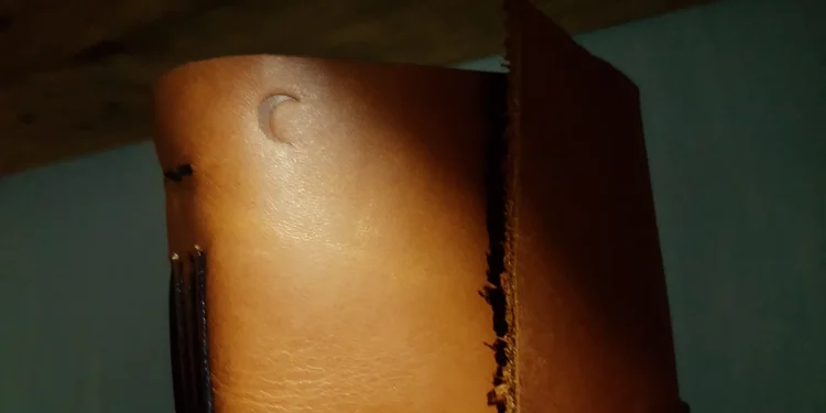 Close Up Of Tan Leather Notebook With Moon Embossing