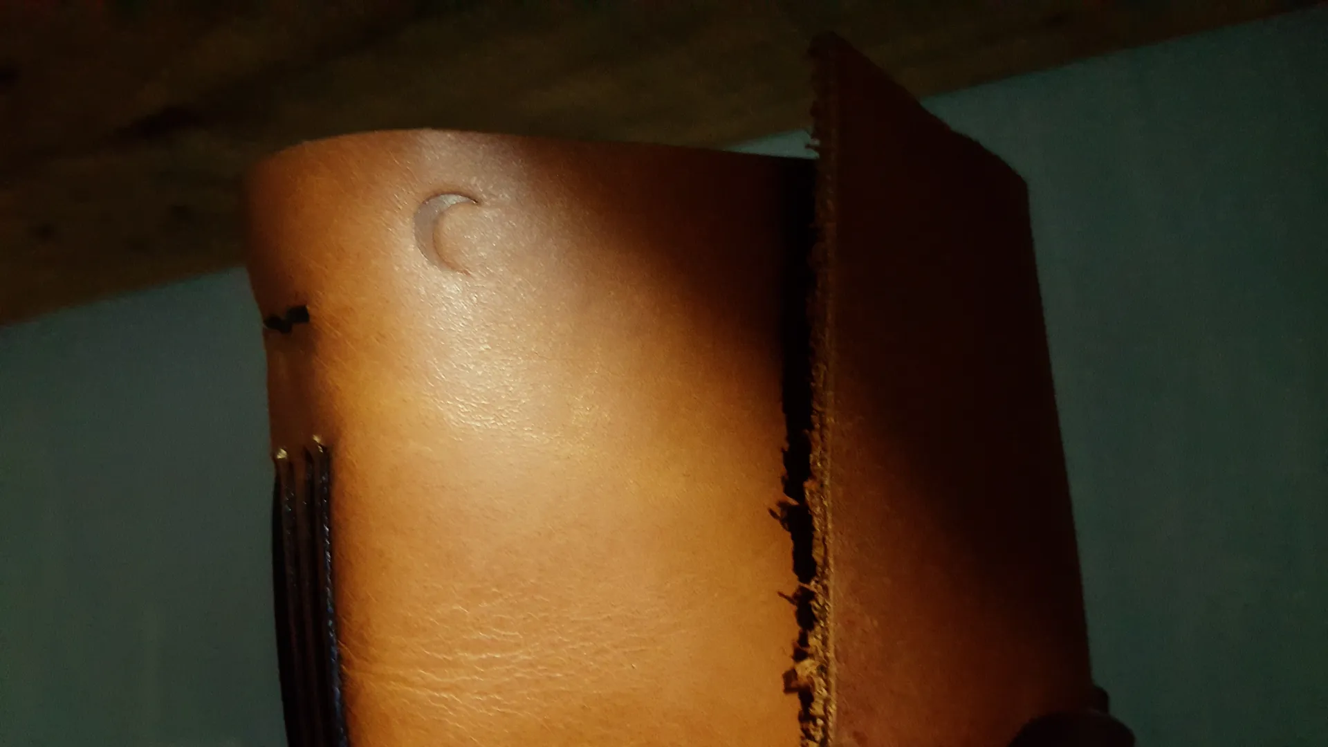 Close Up Of Tan Leather Notebook With Moon Embossing