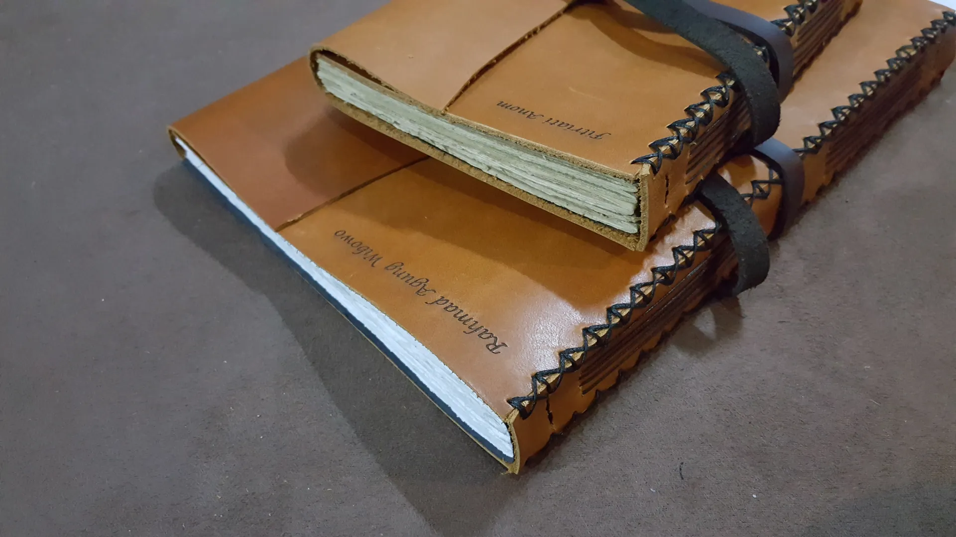 Close Up Of Two Personalized Tan Leather Notebooks
