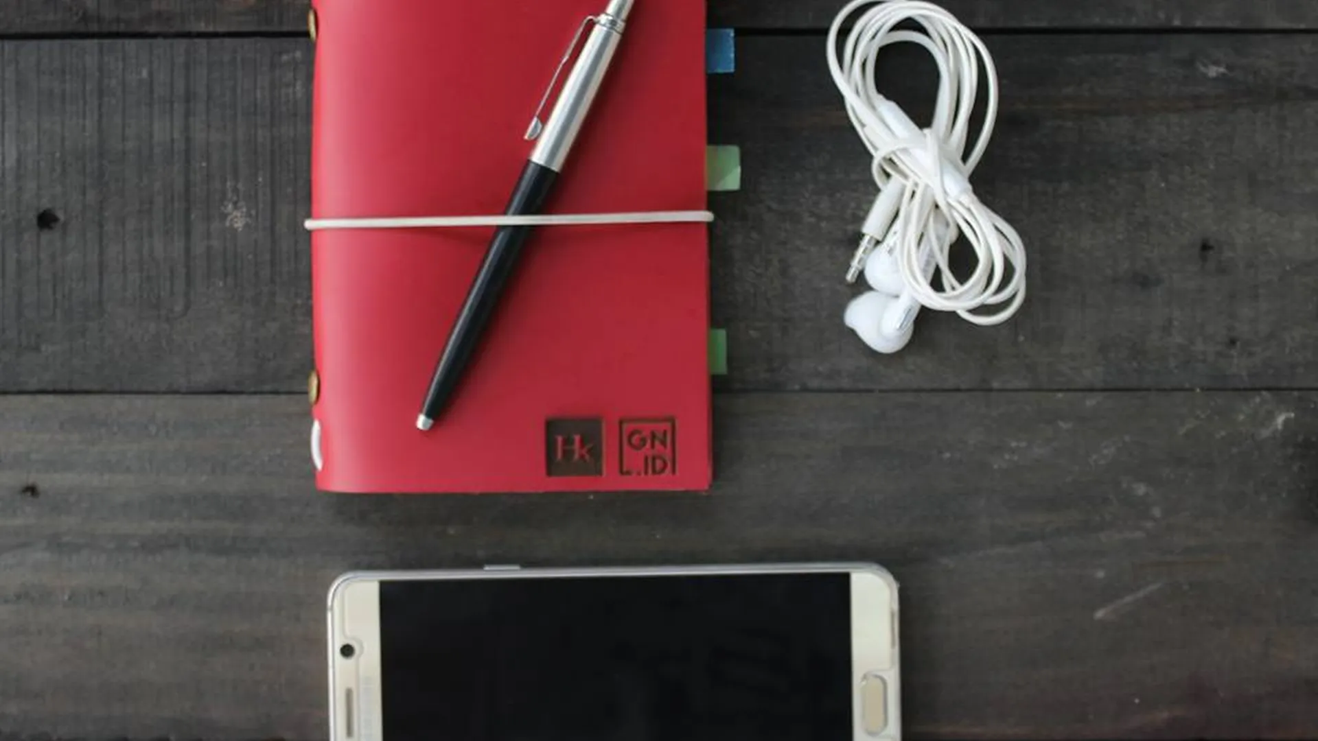 Red Leather Notebook Pen Earphones Smartphone