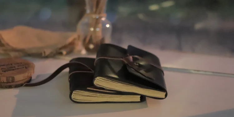 Two Black Leather Notebooks On Table