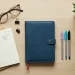 Blue Leather Notebook With Pens And Coffee