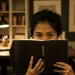 Girl Hiding Behind A Book
