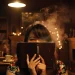 Woman Hiding Face Behind Book In Library