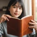 Woman Reading Brown Notebook Window