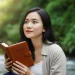 Woman Reading By Stream Nature Book