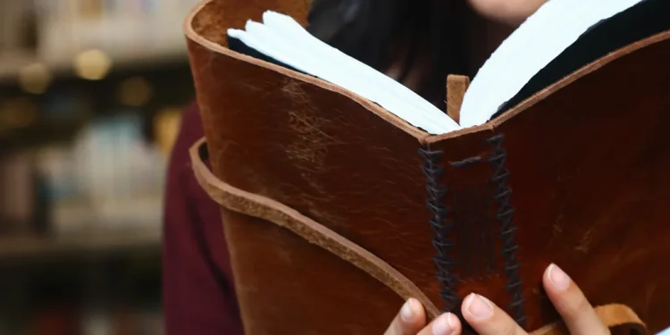 Woman Reading Leather Bound Journal Library