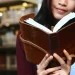 Woman Reading Leather Bound Journal Library