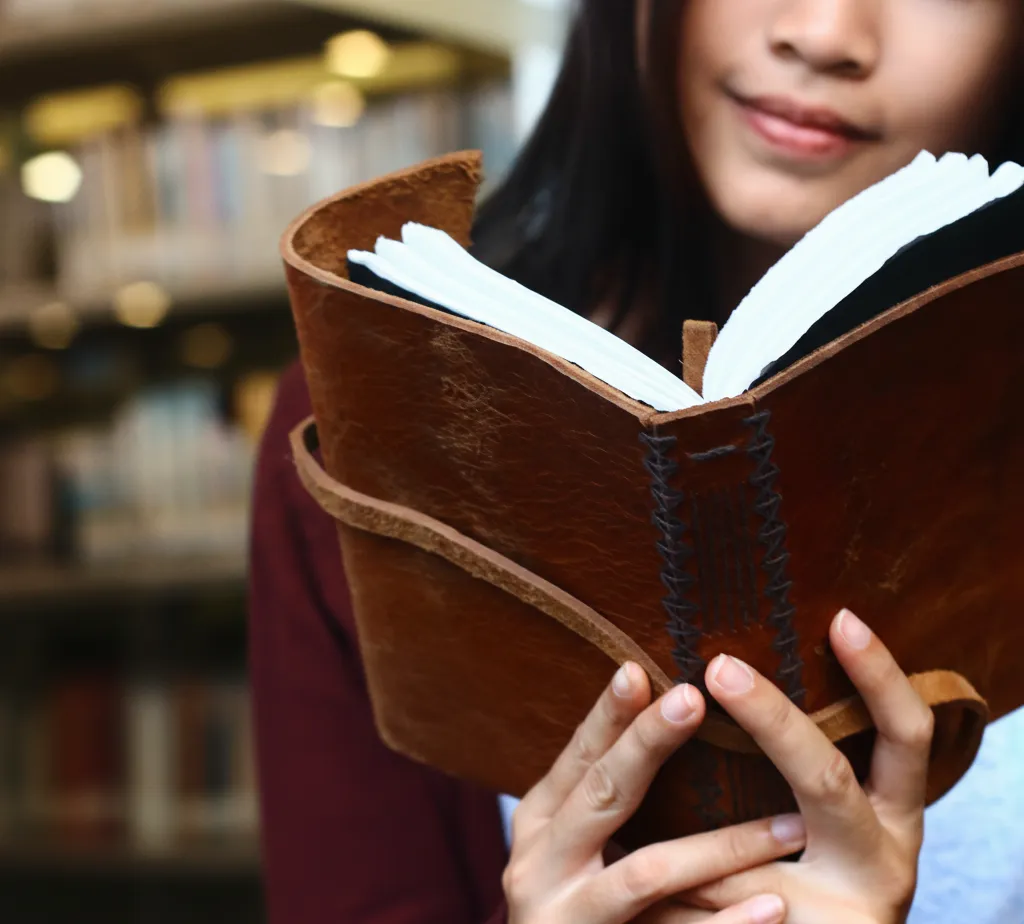 Woman Reading Leather Bound Journal Library