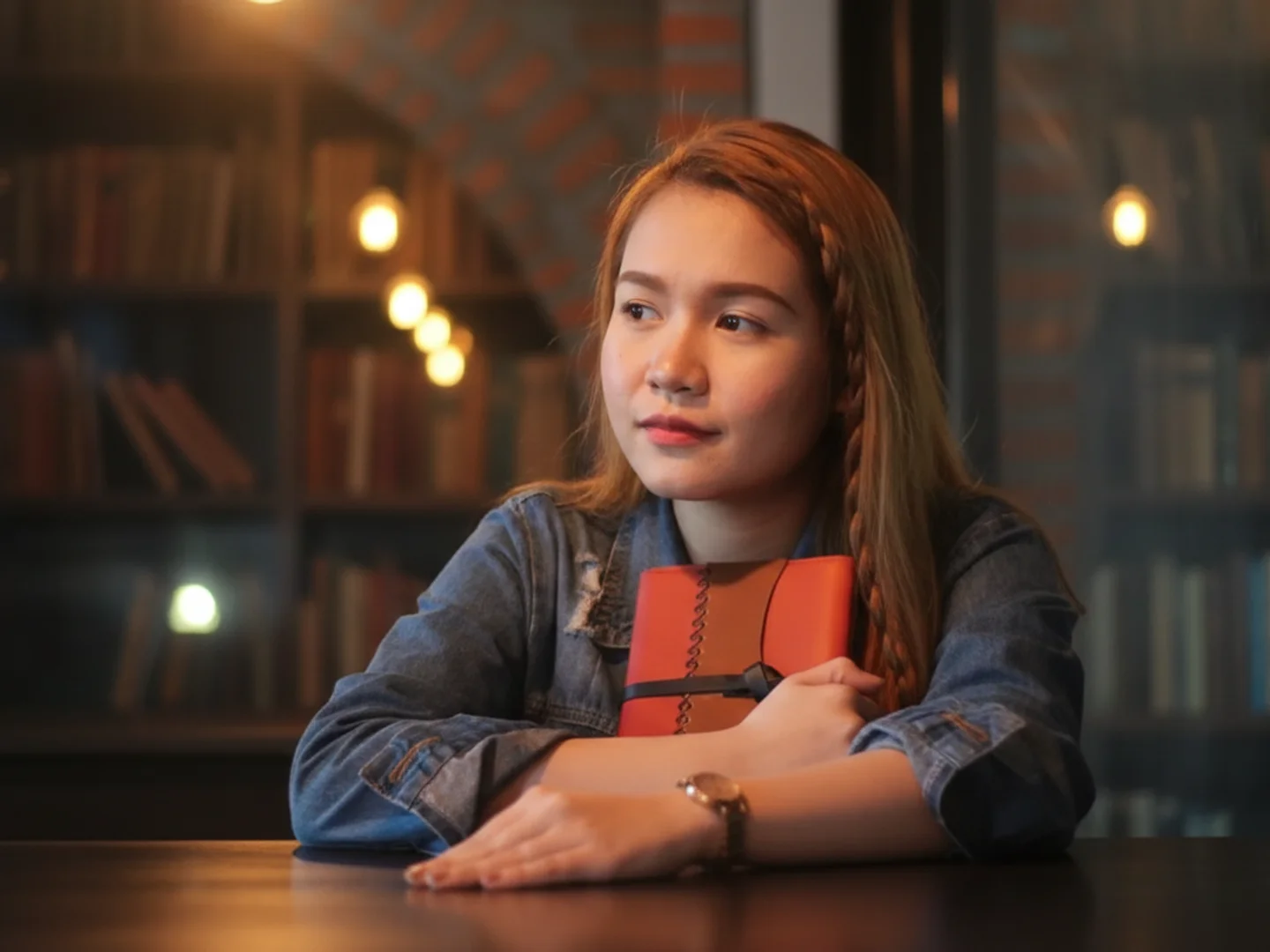 Young Woman Holding Book In Library