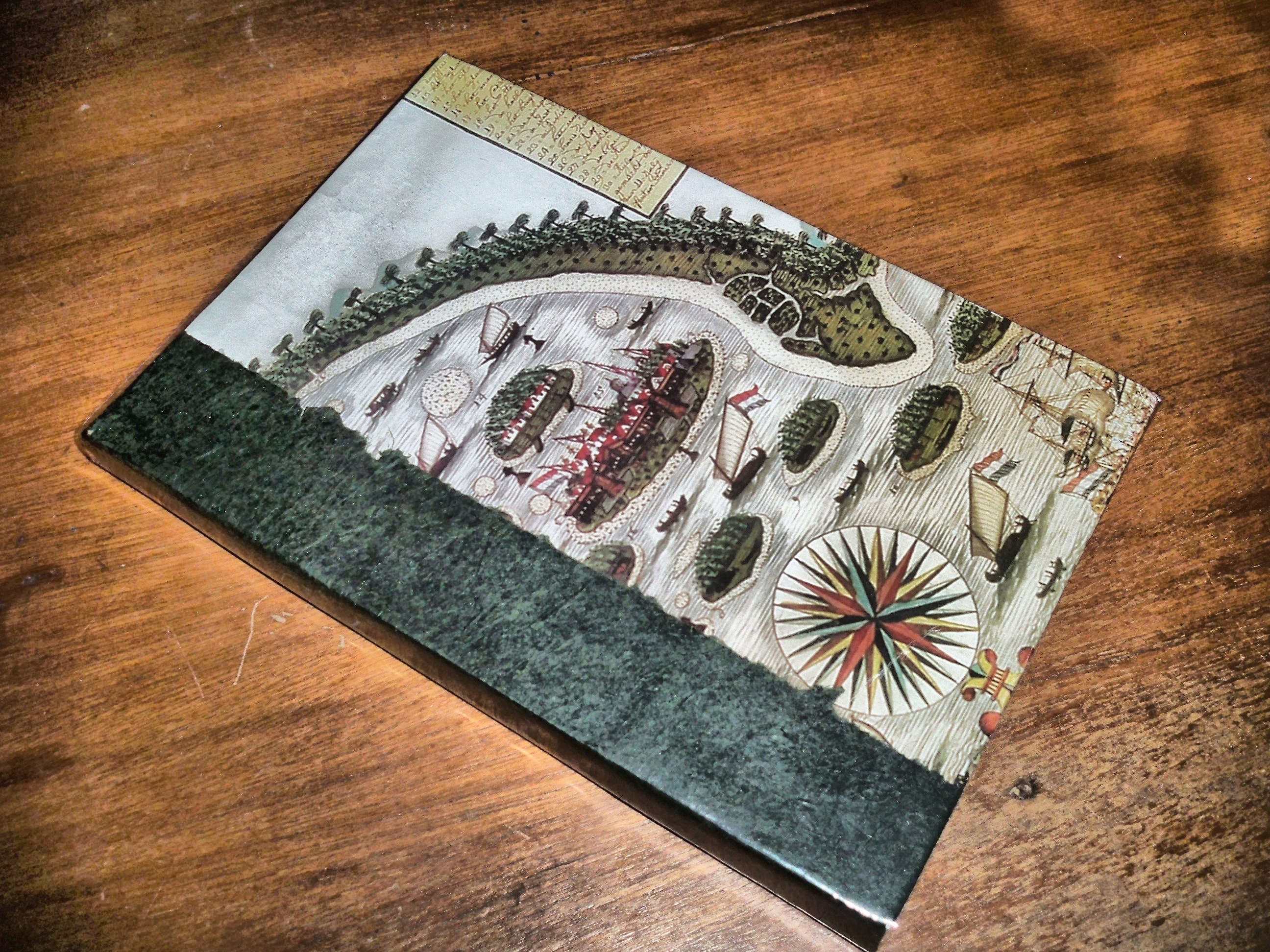 A beautifully crafted 2013 vintage steampunk style bespoke journal resting on a wooden table, representing the early bookbinding craftsmanship of Hibrkraft in Bogor.