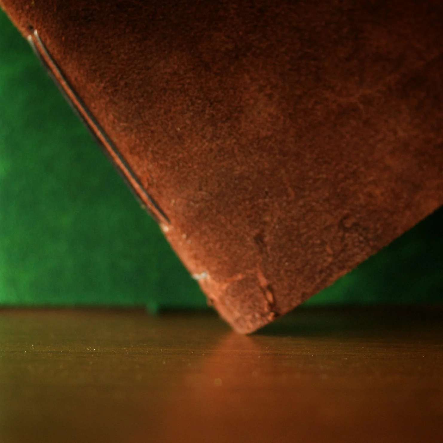 Two suede journal covers, one brown and one green