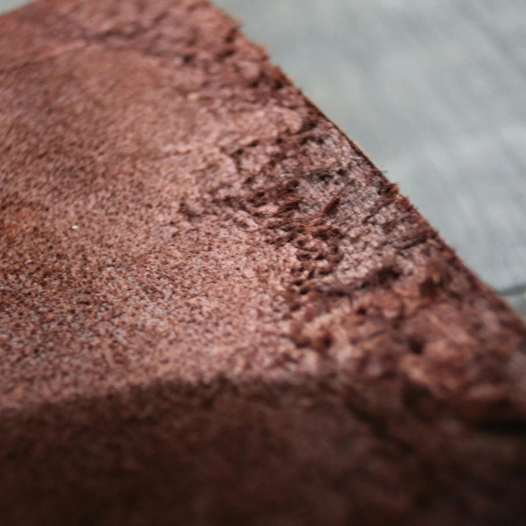 A close-up view of brown suede leather texture.
