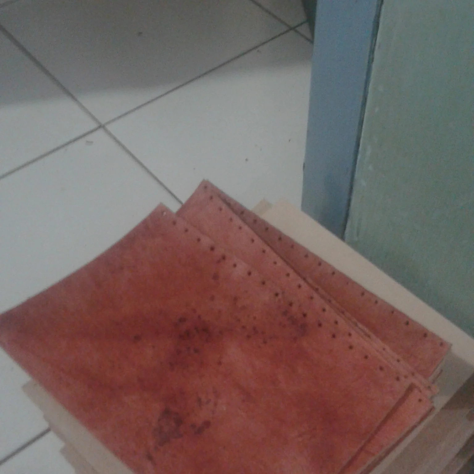 A stack of brown leather sheets that have been punched for the journal making process.
