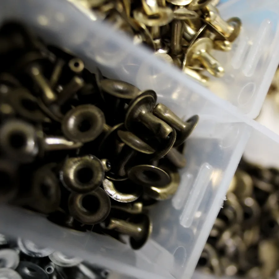 Brass eyelets in a plastic storage box