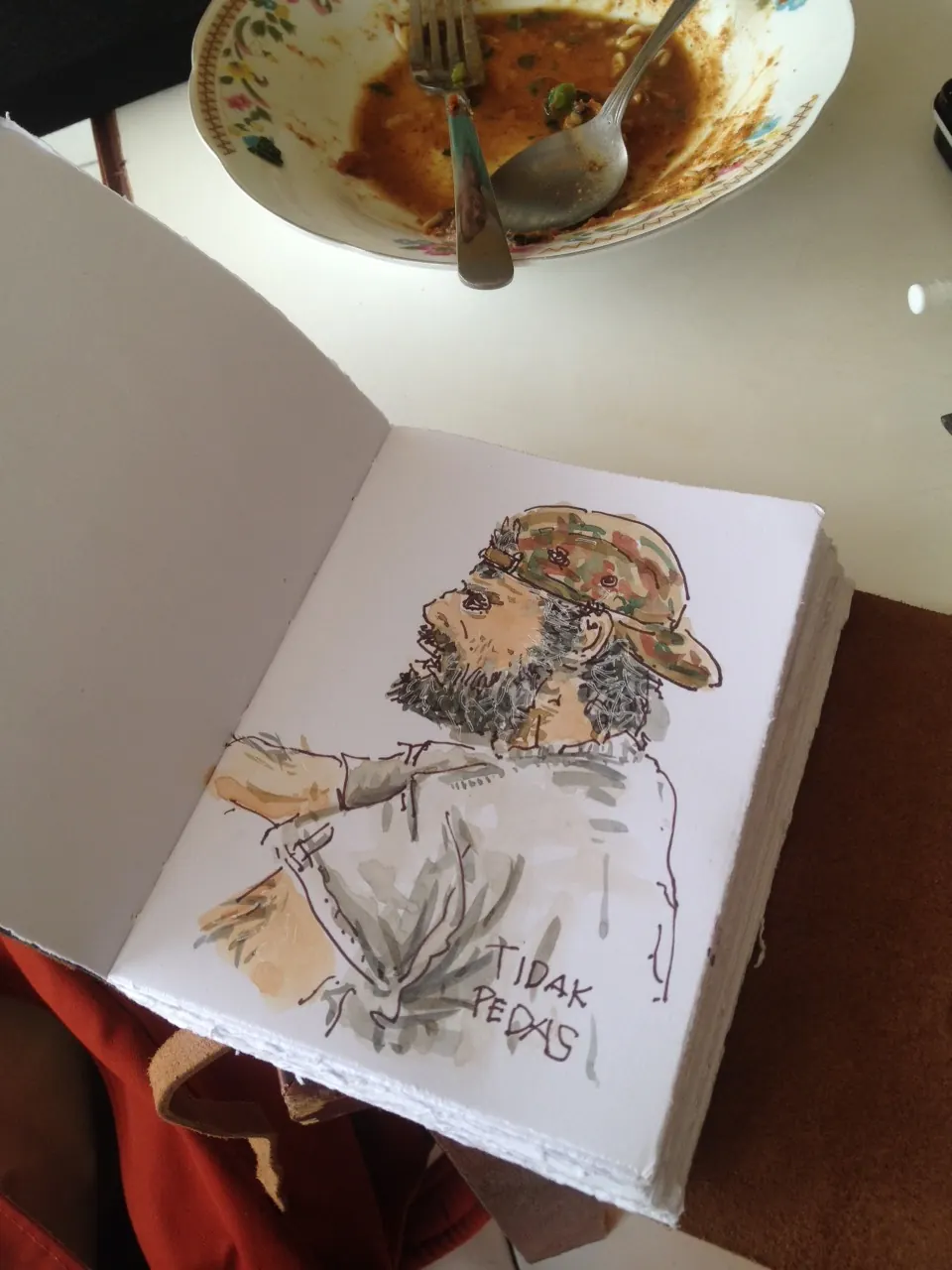 An Angelo project design sketch in a leather journal
