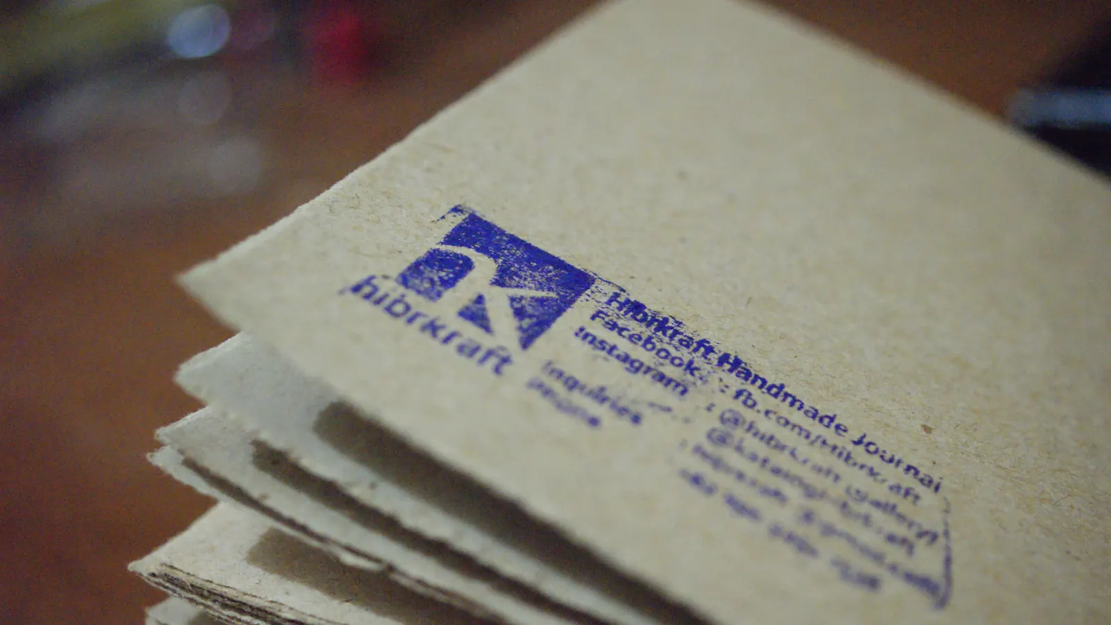 The Hibrkraft logo stamped on a stack of paper.