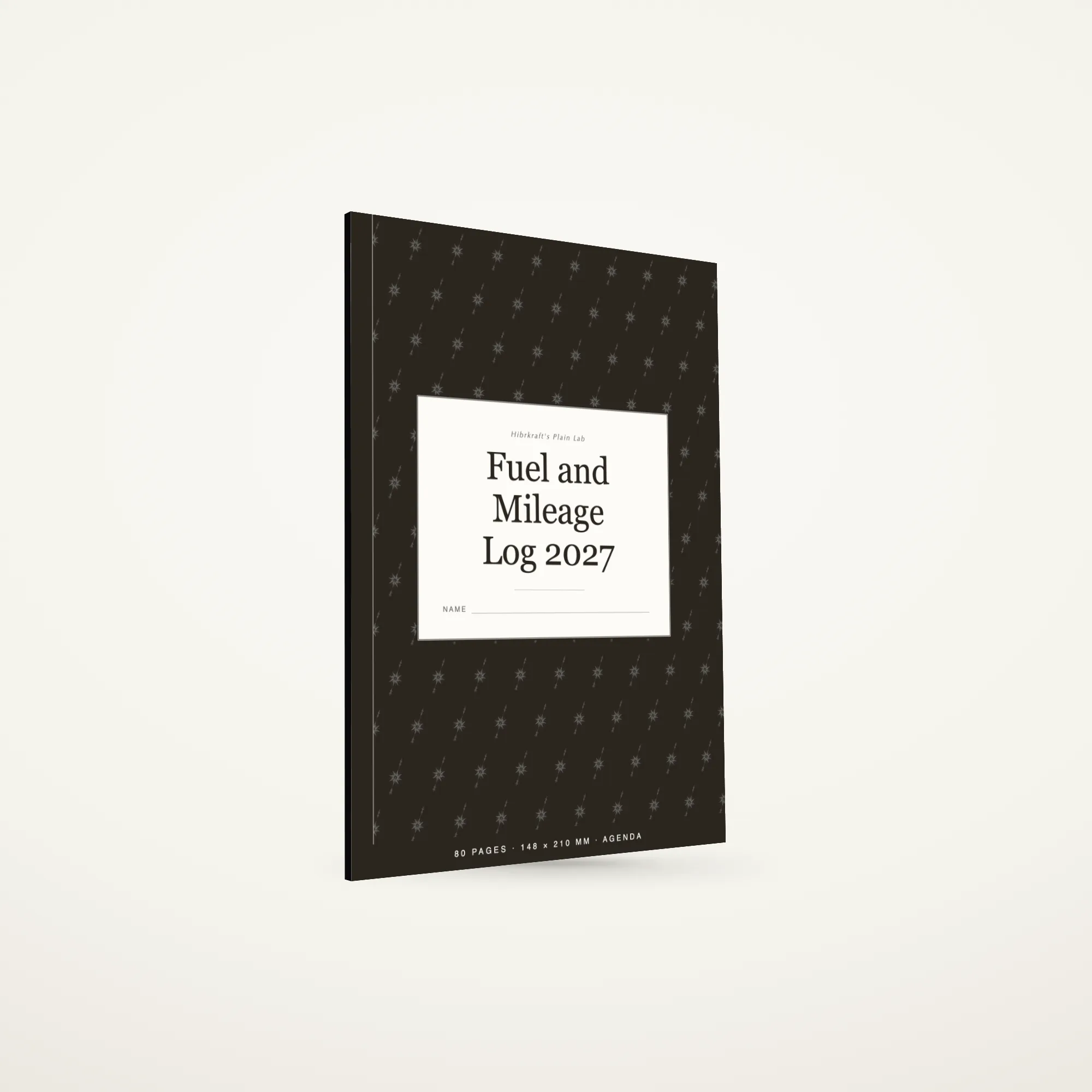 A5 Fuel and Mileage Log 2027 standing closed on a plain surface, dark cover with a fuel gauge motif, about five millimetres thick.