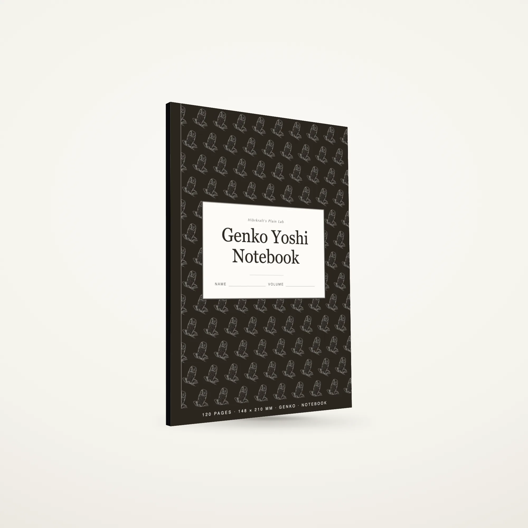 A5 genko yoshi notebook standing closed on a plain surface, composition-style cover with a tiled illustration field and a label plate.