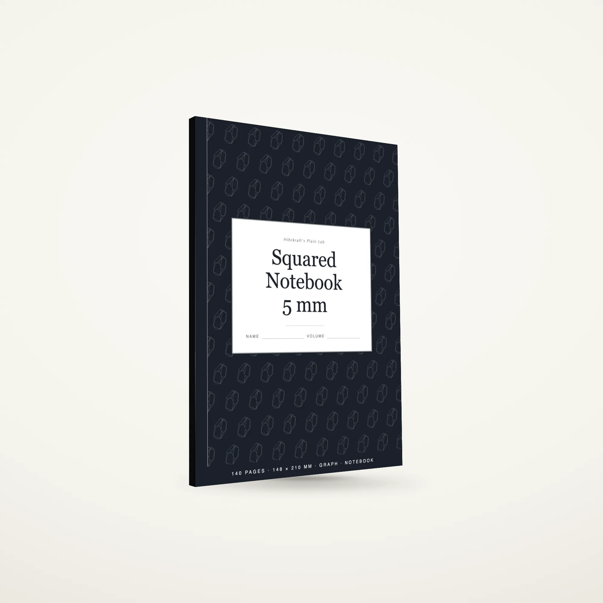 Squared Notebook 5 mm ukuran A5 berdiri tertutup, sampul slate dengan motif batu permata yang dikeluarkan dari warnanya, tebal sekitar delapan milimeter.
