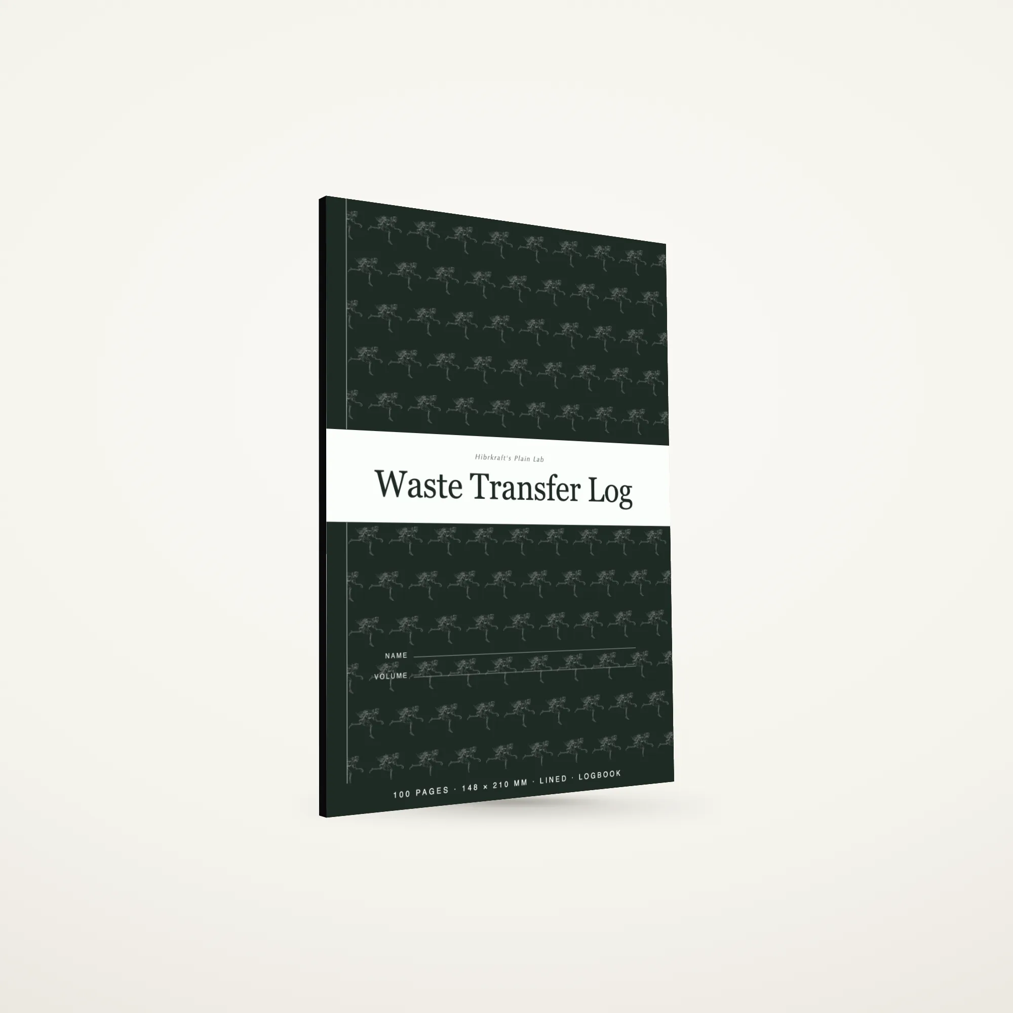 O Waste Transfer Log A5 de pé e fechado sobre uma superfície lisa, capa escura com uma faixa a toda a largura e um motivo de ferramentas, com cerca de seis milímetros de espessura.