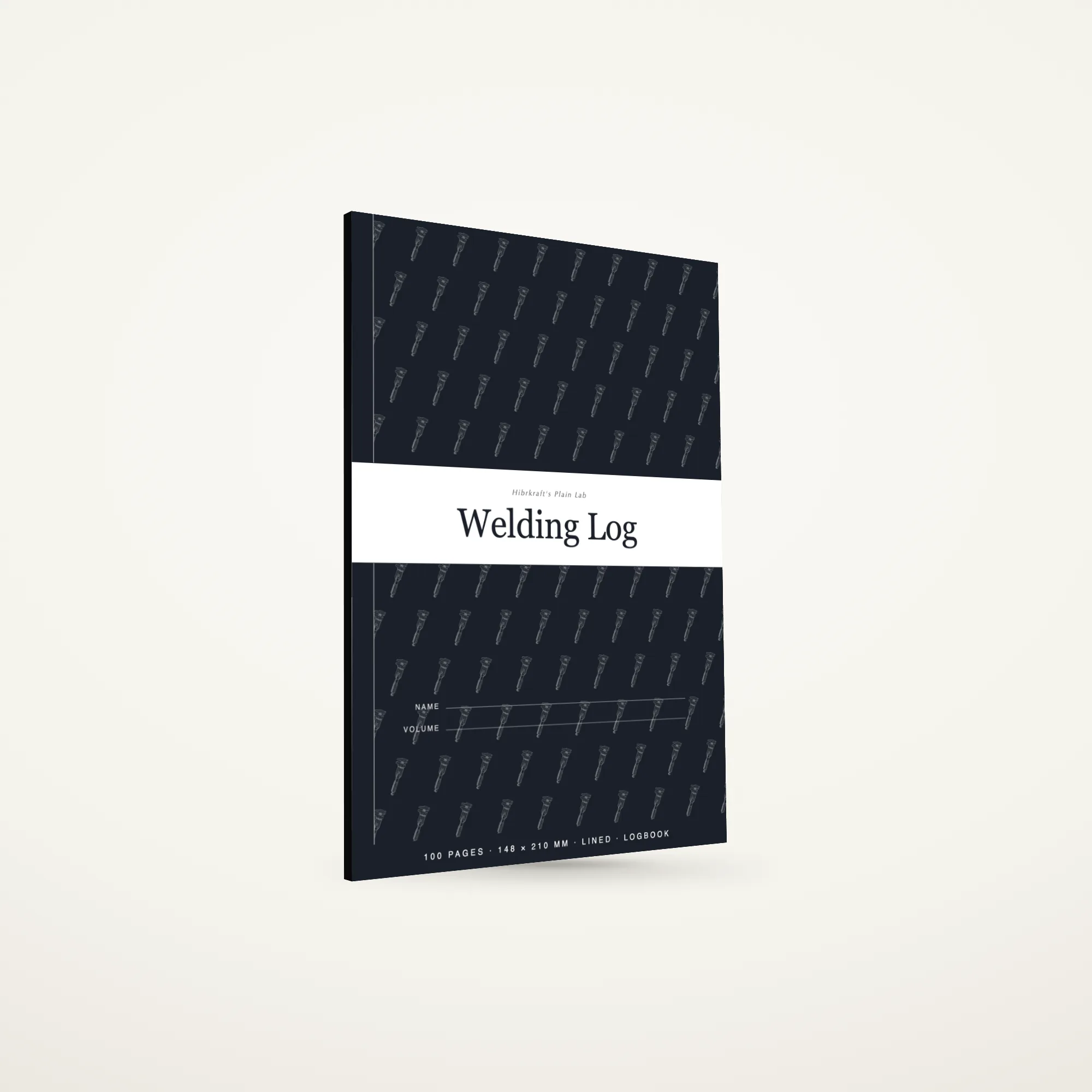 O Welding Log A5 de pé e fechado sobre uma superfície lisa, capa ardósia escura com uma faixa a toda a largura e um motivo de ferramentas, com cerca de seis milímetros de espessura.